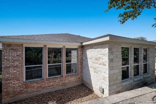 view of property exterior featuring roof with shingles