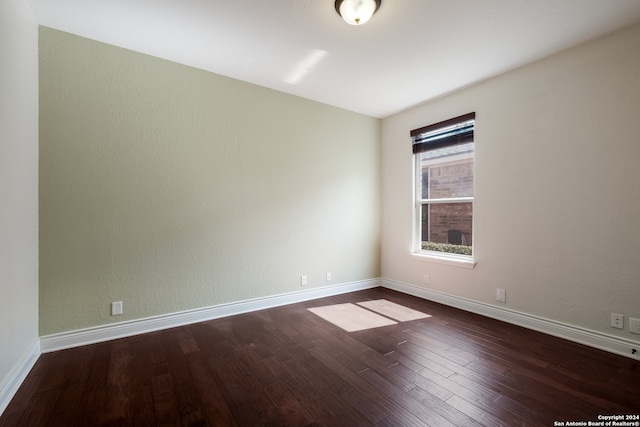 unfurnished room with dark hardwood / wood-style floors