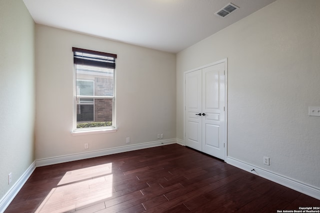 spare room featuring dark hardwood / wood-style flooring