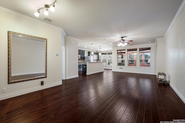 unfurnished living room with dark wood-style floors, crown molding, a ceiling fan, baseboards, and visible vents