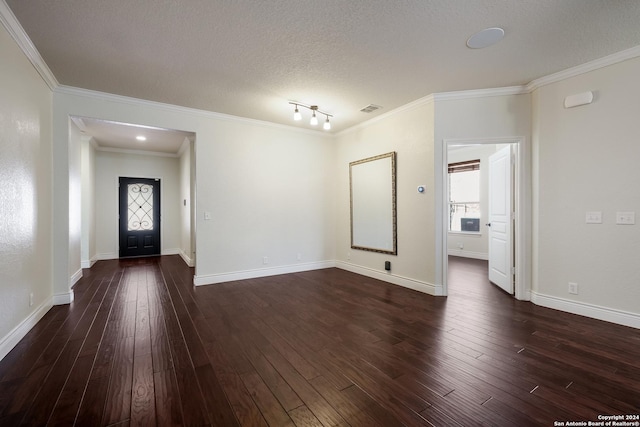 unfurnished living room with dark wood-type flooring, a wealth of natural light, and crown molding