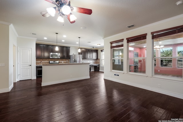 kitchen featuring tasteful backsplash, dark brown cabinets, a center island, hanging light fixtures, and stainless steel appliances