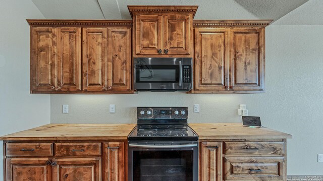 165 Lakeview Cir, La Vernia, TX 78121 - kitchen featuring butcher block counters and black range with electric cooktop