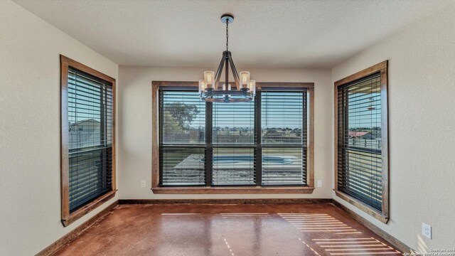 165 Lakeview Cir, La Vernia, TX 78121 - unfurnished dining area featuring a notable chandelier and a textured ceiling