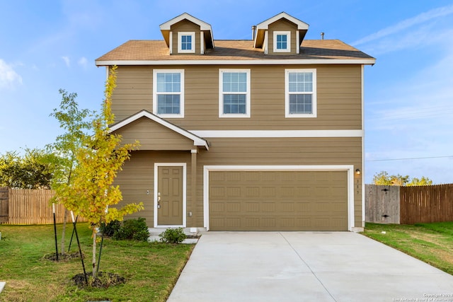 view of front of house with a front yard and a garage