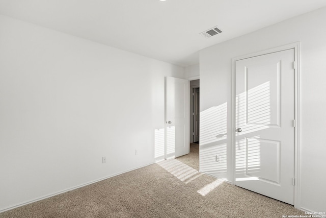 unfurnished bedroom featuring light colored carpet