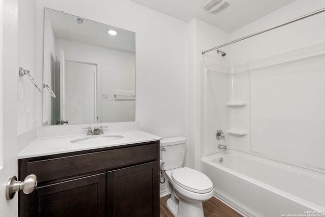 full bathroom with toilet, vanity, wood-type flooring, and washtub / shower combination