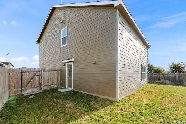 back of house with a yard