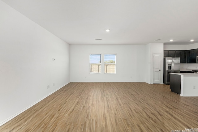 unfurnished living room with light hardwood / wood-style flooring