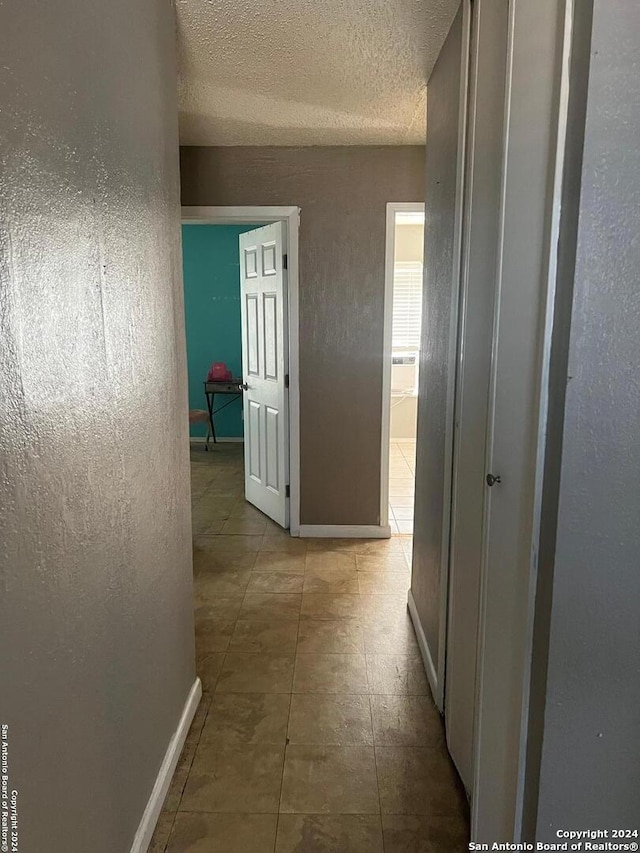 hallway featuring a textured ceiling