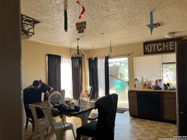 dining area with a wealth of natural light and a textured ceiling