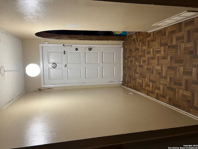 garage featuring wood walls