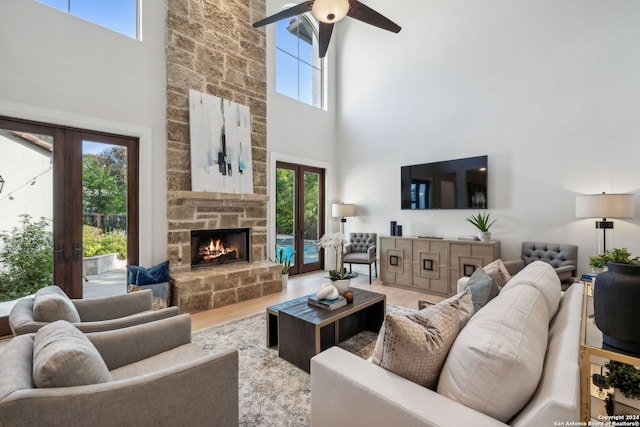 living room featuring hardwood / wood-style flooring, a wealth of natural light, and a high ceiling