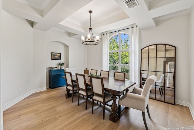 dining space featuring coffered ceiling, beam ceiling, ornamental molding, light wood-type flooring, and a chandelier