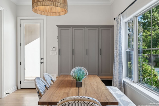 dining room featuring crown molding and light wood-type flooring