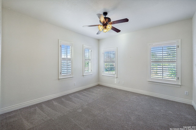 unfurnished room featuring ceiling fan and dark colored carpet