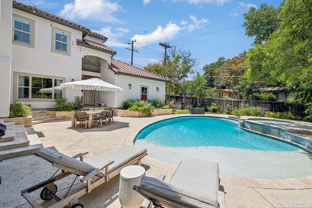 view of pool with a patio area and an in ground hot tub