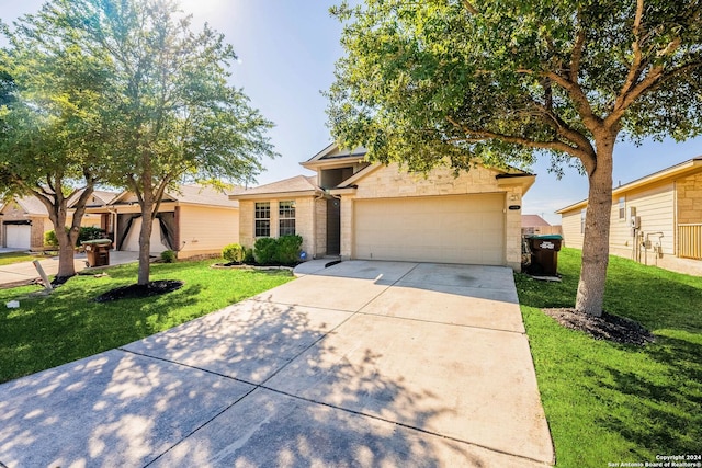 view of front of home with a garage and a front lawn