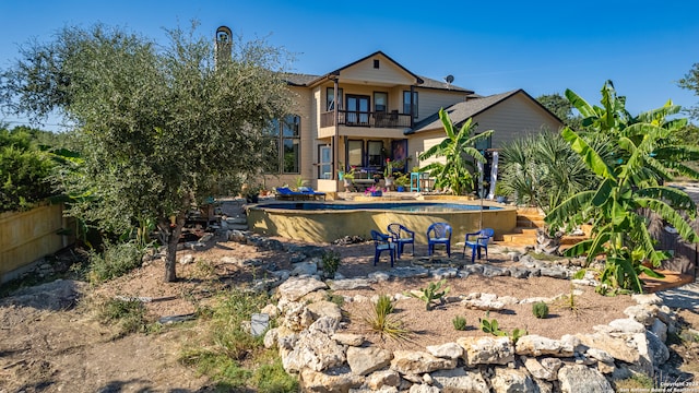 back of property featuring a patio area and a balcony