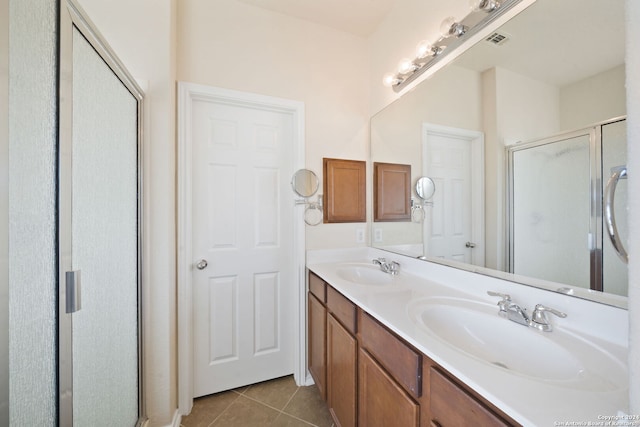 bathroom featuring tile patterned floors, vanity, and an enclosed shower