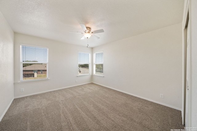 unfurnished room with carpet flooring, a textured ceiling, and ceiling fan