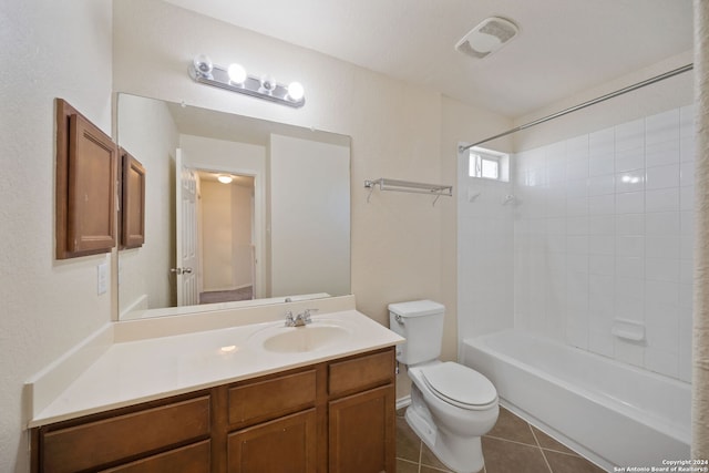 full bathroom featuring tile patterned floors, vanity, toilet, and tiled shower / bath combo