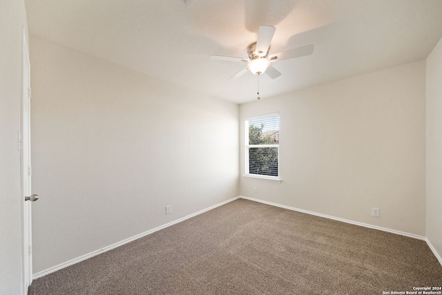 spare room featuring carpet flooring and ceiling fan