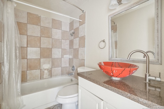 full bathroom with vanity, toilet, shower / bathtub combination with curtain, and a textured ceiling