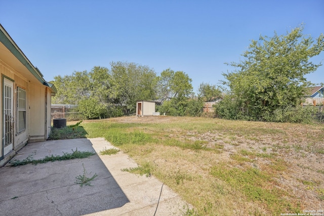 view of yard featuring a storage unit and a patio area