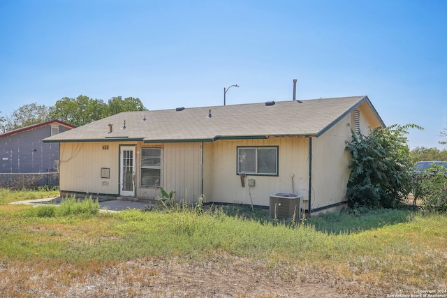 rear view of property with central AC