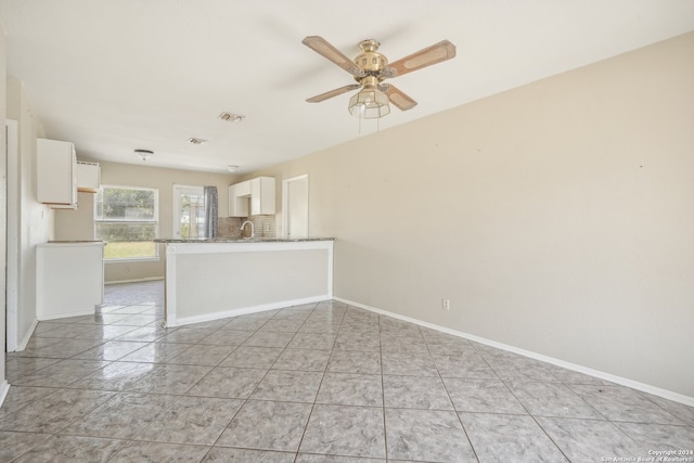 unfurnished room featuring sink, light tile patterned flooring, and ceiling fan