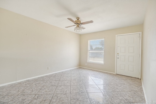 tiled empty room with ceiling fan