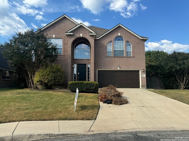 front facade with a front yard and a garage