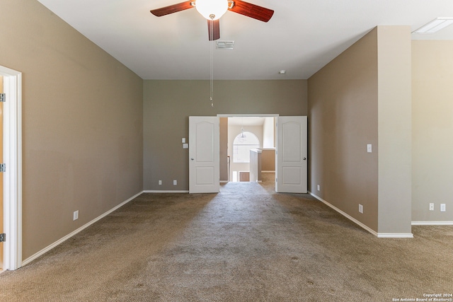 spare room featuring ceiling fan and carpet floors