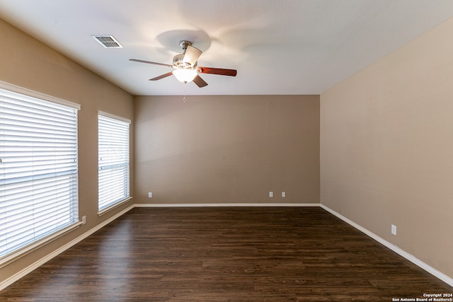 spare room featuring ceiling fan and dark hardwood / wood-style flooring