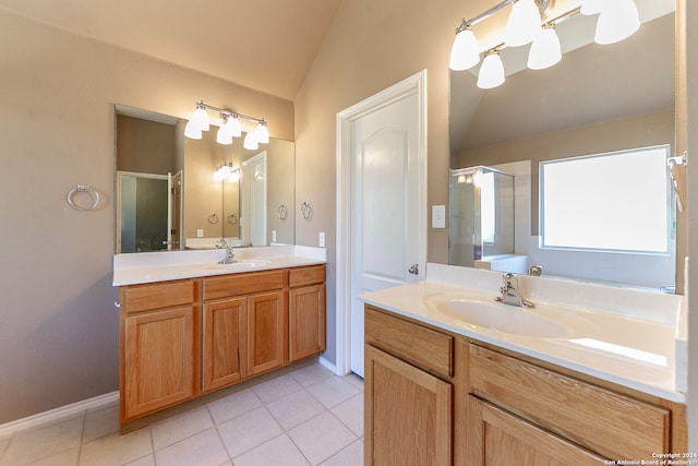 bathroom with vanity, vaulted ceiling, a shower with shower door, and tile patterned floors