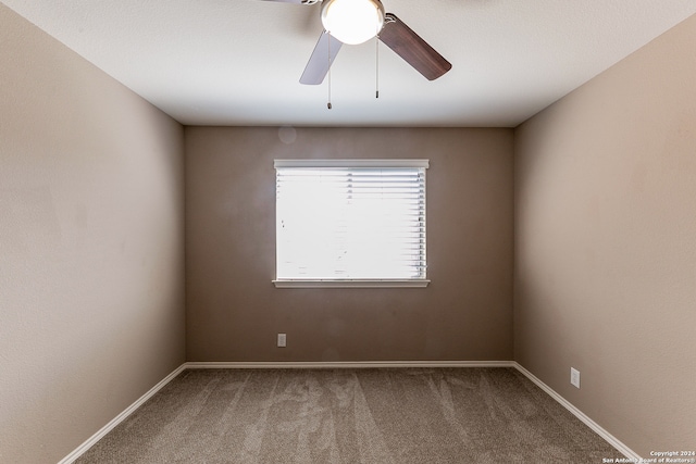 empty room with carpet flooring and ceiling fan