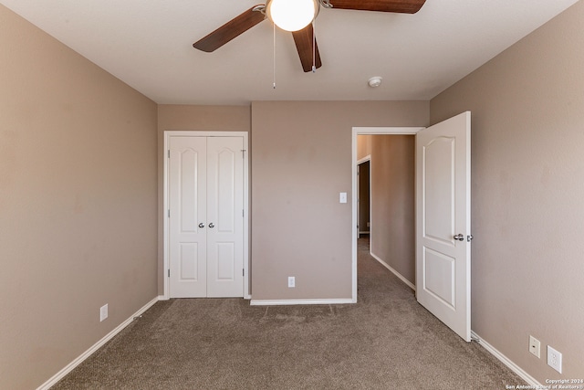 unfurnished bedroom with a closet, carpet floors, and ceiling fan