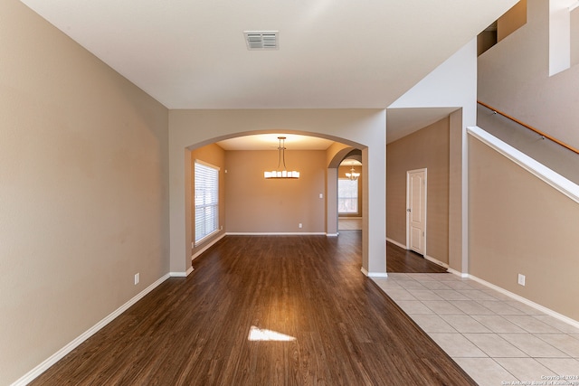 interior space featuring an inviting chandelier and light wood-type flooring