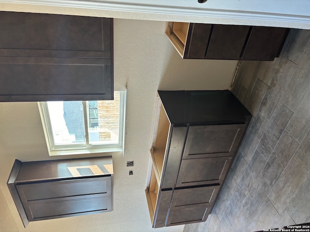 kitchen featuring backsplash and dark brown cabinetry