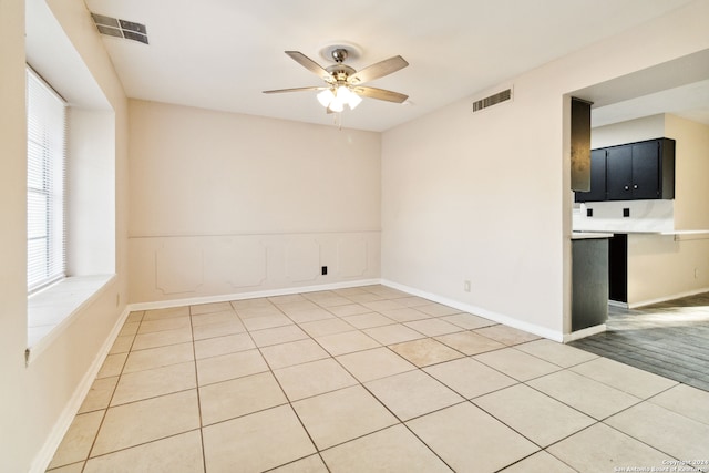 tiled empty room with ceiling fan