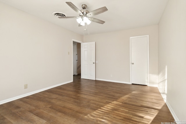 spare room featuring ceiling fan and dark hardwood / wood-style flooring