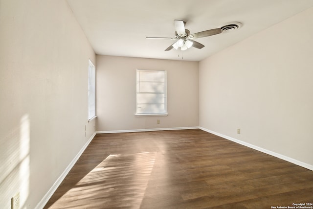 spare room with dark hardwood / wood-style floors and ceiling fan