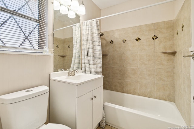 full bathroom with vanity, shower / bath combo with shower curtain, and toilet