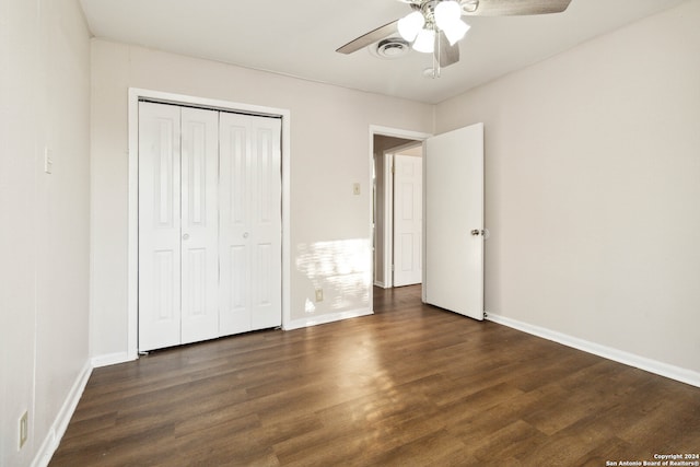 unfurnished bedroom featuring ceiling fan, a closet, and dark hardwood / wood-style flooring