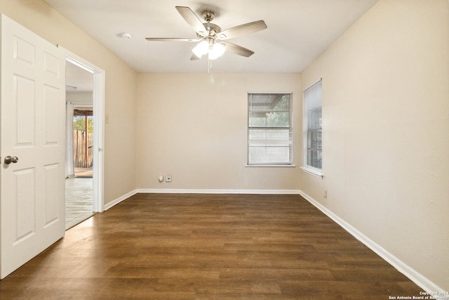 empty room with dark hardwood / wood-style floors and ceiling fan