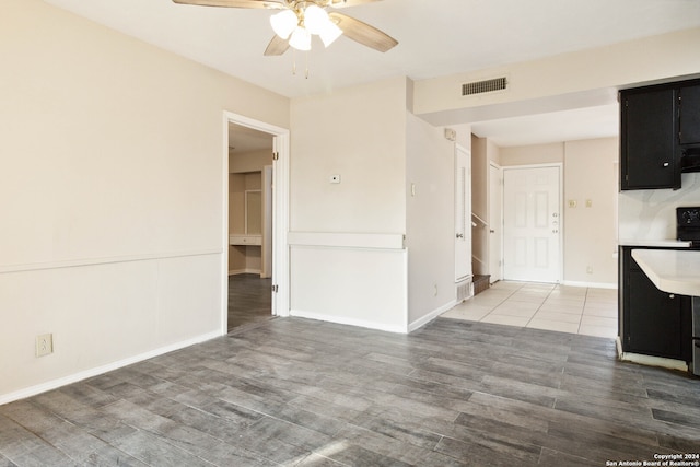 interior space with wood-type flooring and ceiling fan