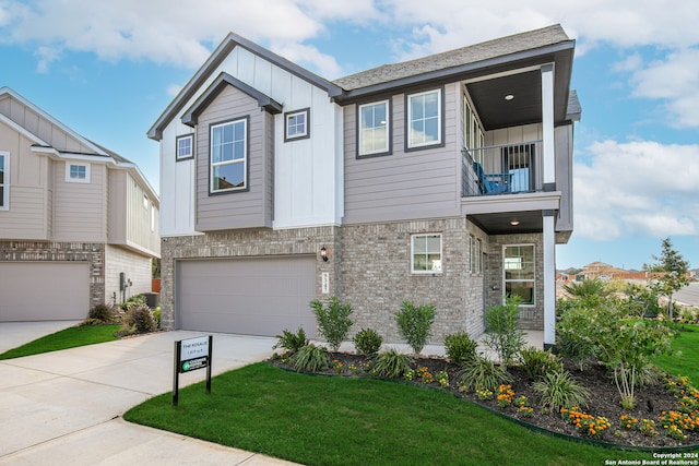 view of front of house featuring a front lawn, a garage, and a balcony