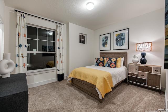 carpeted bedroom with a textured ceiling