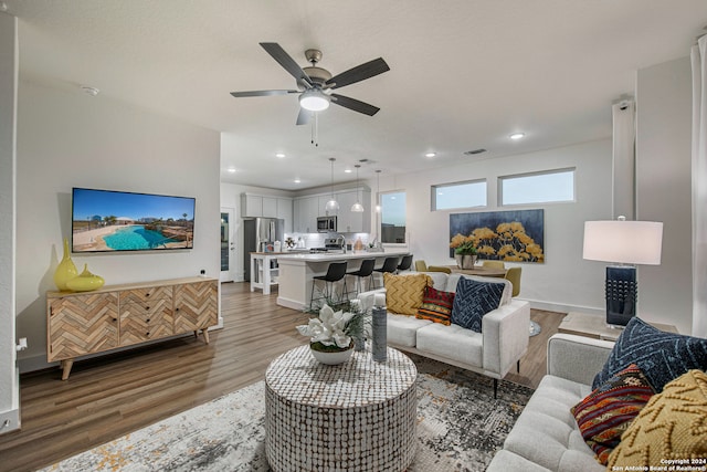 living room with ceiling fan and hardwood / wood-style floors